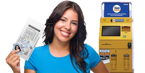 Person holding a renewed Idaho vehicle registration with a DMV kiosk in the background